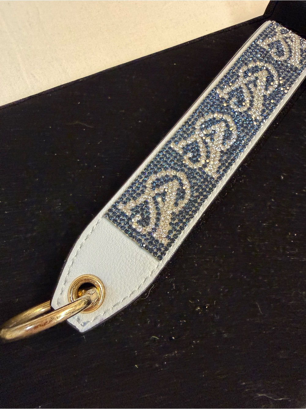 Embellished White Leather Wristlet Strap with Blue Crystal Accent
